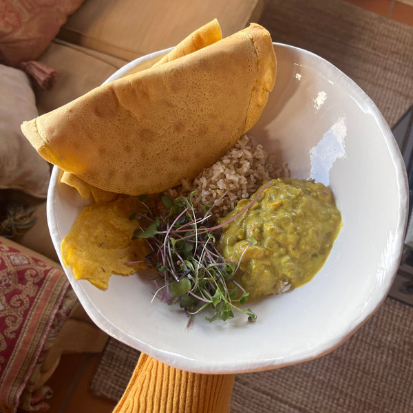 lentil curry with chickpea pancakes and sprouted greens