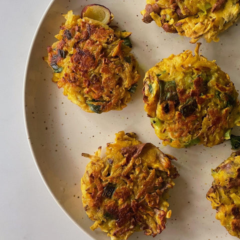 turmeric and saffron fritters on a plate by hannah trueman